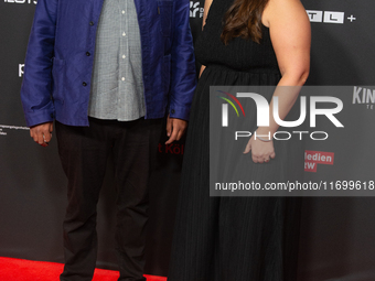 Michael Premo, a filmmaker who receives the Der Phoenix Preis with his companion, is seen on the red carpet of Film Palast in Cologne, Germa...