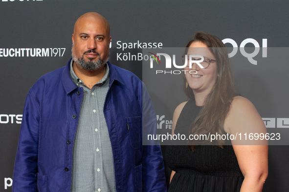 Michael Premo, a filmmaker who receives the Der Phoenix Preis with his companion, is seen on the red carpet of Film Palast in Cologne, Germa...