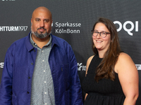 Michael Premo, a filmmaker who receives the Der Phoenix Preis with his companion, is seen on the red carpet of Film Palast in Cologne, Germa...