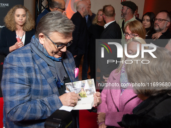 Hape Kerkeling, a German actor and writer, is greeted by his fans on the red carpet of the photocall for ''Total Normal - Hape Kerkeling'' a...