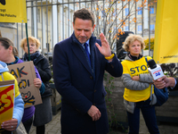 Mayor Rafal Trzaskowski reacts to a loud megafone outside city hall during a demonstration against conditions in cat shelters in Warsaw, Pol...