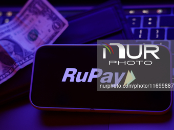 A laptop keyboard, a banknote, a wallet and RuPay logo displayed on a phone screen are seen in this illustration photo taken in Krakow, Pola...