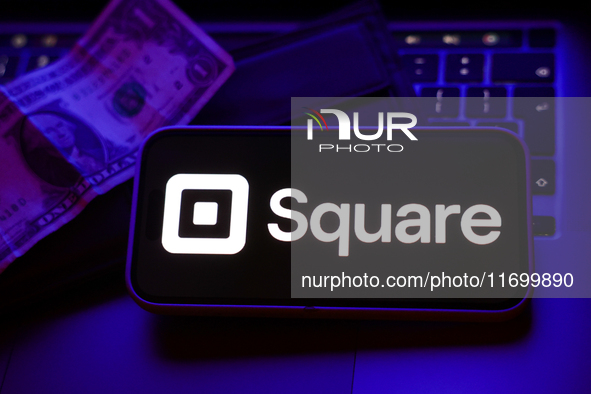 A laptop keyboard, a banknote, a wallet and Square logo displayed on a phone screen are seen in this illustration photo taken in Krakow, Pol...