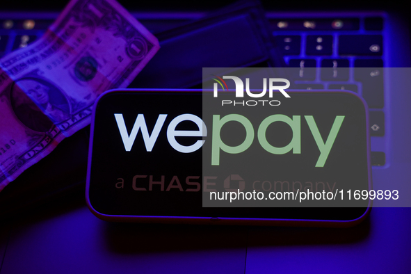 A laptop keyboard, a banknote, a wallet and WePay logo displayed on a phone screen are seen in this illustration photo taken in Krakow, Pola...