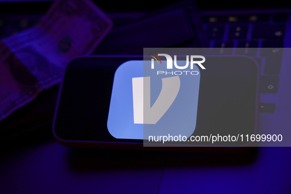 A laptop keyboard, a banknote, a wallet and Venmo logo displayed on a phone screen are seen in this illustration photo taken in Krakow, Pola...