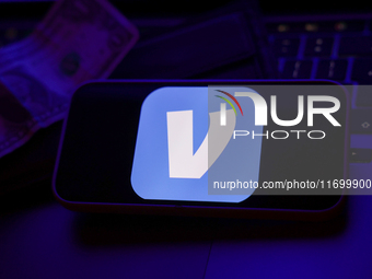 A laptop keyboard, a banknote, a wallet and Venmo logo displayed on a phone screen are seen in this illustration photo taken in Krakow, Pola...