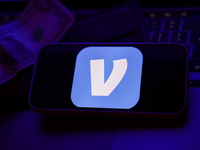 A laptop keyboard, a banknote, a wallet and Venmo logo displayed on a phone screen are seen in this illustration photo taken in Krakow, Pola...