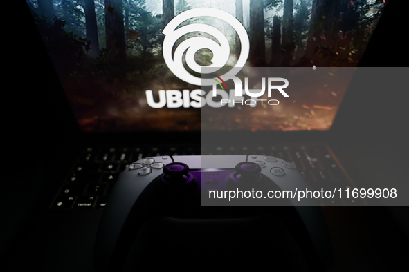 Ubisoft logo displayed on a laptop screen and DualSense controller are seen in this illustration photo taken in Krakow, Poland on October 23...