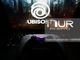 Ubisoft logo displayed on a laptop screen and DualSense controller are seen in this illustration photo taken in Krakow, Poland on October 23...