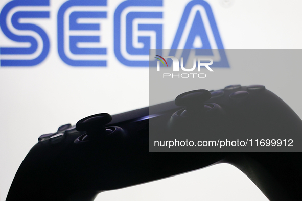 Sega logo displayed on a laptop screen and DualSense controller are seen in this illustration photo taken in Krakow, Poland on October 23, 2...