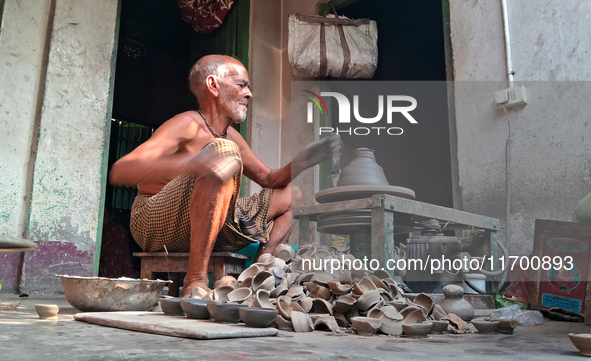 An elderly potter makes earthen diyas ahead of the Diwali Festival in Siliguri, India, on October 24, 2024. 