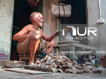 An elderly potter makes earthen diyas ahead of the Diwali Festival in Siliguri, India, on October 24, 2024. (