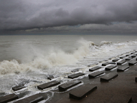 Waves overflow onto a damaged sea front before Cyclone Dana in Digha, West Bengal, on October 24, 2024. Cyclonic storm Dana currently barrel...