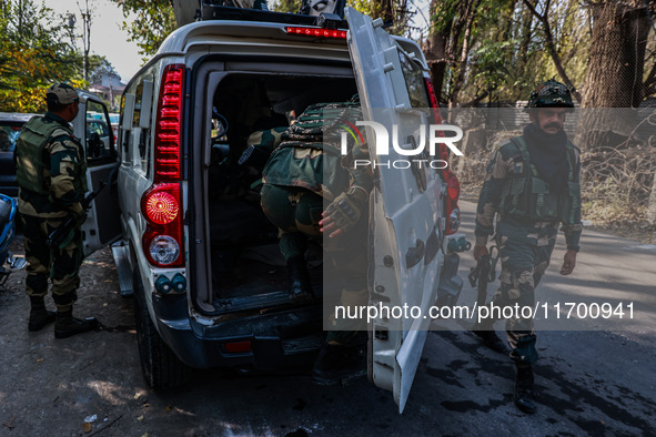 Security officials stand outside the court after a cop is injured when a grenade accidentally explodes in the Baramulla Court Complex in Jam...