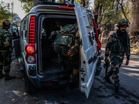 Security officials stand outside the court after a cop is injured when a grenade accidentally explodes in the Baramulla Court Complex in Jam...