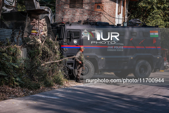 Security officials stand outside the court after a cop is injured when a grenade accidentally explodes in the Baramulla Court Complex in Jam...