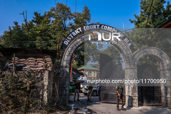 Security officials stand outside the court after a cop is injured when a grenade accidentally explodes in the Baramulla Court Complex in Jam...