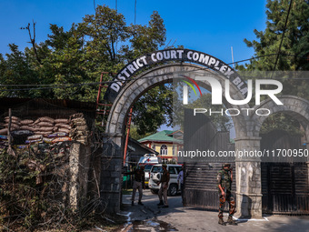 Security officials stand outside the court after a cop is injured when a grenade accidentally explodes in the Baramulla Court Complex in Jam...