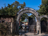 Security officials stand outside the court after a cop is injured when a grenade accidentally explodes in the Baramulla Court Complex in Jam...