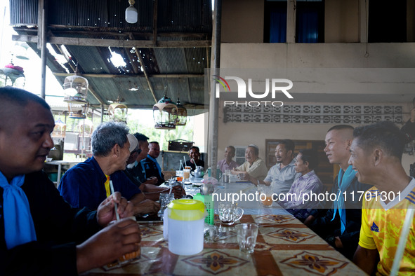 Community members meet with the army to check on the situation in their village near Pattani. Special Forces, the Black Army, and Volunteer...