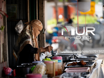 A street food vendor prepares lunch by the road in Pattani. Special Forces, the Black Army, and Volunteer Force Operations in Thailand's Dee...