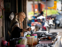 A street food vendor prepares lunch by the road in Pattani. Special Forces, the Black Army, and Volunteer Force Operations in Thailand's Dee...