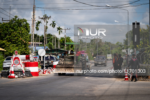 A person driving a tractor passes through an armed checkpoint in Pattani. Special Forces, the Black Army, and Volunteer Force Operations in...