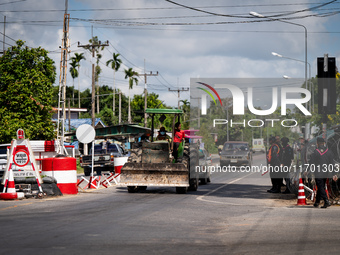 A person driving a tractor passes through an armed checkpoint in Pattani. Special Forces, the Black Army, and Volunteer Force Operations in...