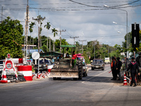 A person driving a tractor passes through an armed checkpoint in Pattani. Special Forces, the Black Army, and Volunteer Force Operations in...