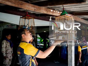 A member of the community wishes for luck with his bird. Special Forces, the Black Army, and Volunteer Force Operations in Thailand's Deep S...