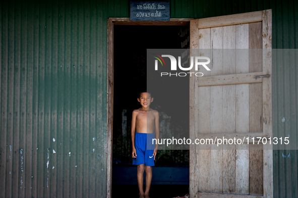 A boy stands for a portrait at his village home in rural Pattani. Special Forces, the Black Army, and Volunteer Force Operations in Thailand...