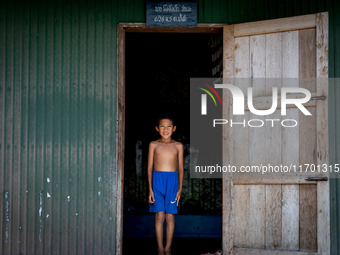 A boy stands for a portrait at his village home in rural Pattani. Special Forces, the Black Army, and Volunteer Force Operations in Thailand...