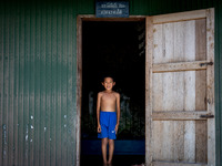 A boy stands for a portrait at his village home in rural Pattani. Special Forces, the Black Army, and Volunteer Force Operations in Thailand...