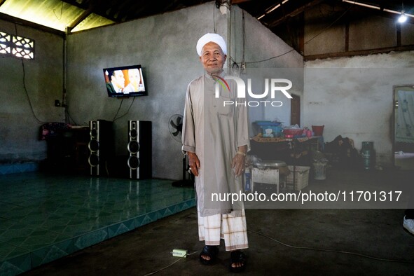 Yuso Sani, Imam of the Numdum Community, Pattani, stands for a portrait in his village. Special Forces, the Black Army, and Volunteer Force...