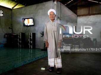 Yuso Sani, Imam of the Numdum Community, Pattani, stands for a portrait in his village. Special Forces, the Black Army, and Volunteer Force...