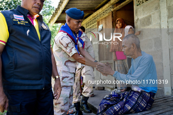 Members of the army and volunteer task force provide healthcare and other necessary supplies to families in need in villages around Pattani....