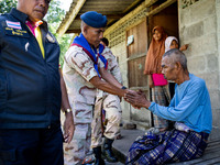 Members of the army and volunteer task force provide healthcare and other necessary supplies to families in need in villages around Pattani....