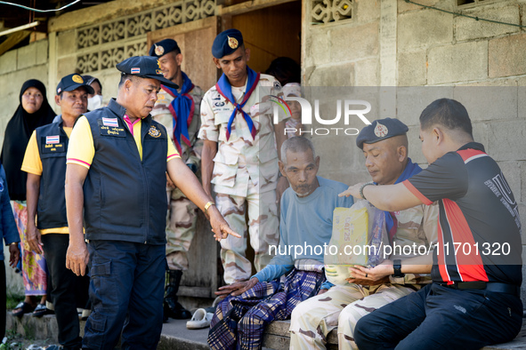 Members of the army and volunteer task force provide healthcare and other necessary supplies to families in need in villages around Pattani....