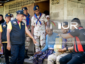 Members of the army and volunteer task force provide healthcare and other necessary supplies to families in need in villages around Pattani....