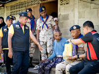 Members of the army and volunteer task force provide healthcare and other necessary supplies to families in need in villages around Pattani....