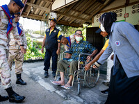 Members of the army and volunteer task force provide healthcare and other necessary supplies to families in need in villages around Pattani....