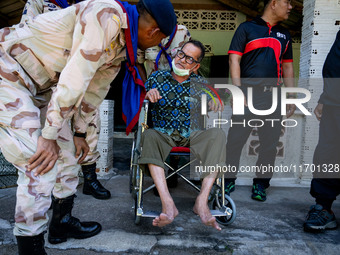 Members of the army and volunteer task force provide healthcare and other necessary supplies to families in need in villages around Pattani....