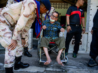 Members of the army and volunteer task force provide healthcare and other necessary supplies to families in need in villages around Pattani....