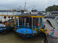 Workers tie a boat to a jetty as a precautionary measure against Cyclone Dana in Kolkata, India, on October 24, 2024. The Regional Meteorolo...