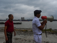 Police officials patrol a riverside in Kolkata, India, on October 24, 2024, as a precautionary measure ahead of the landfall of Cyclone Dana...