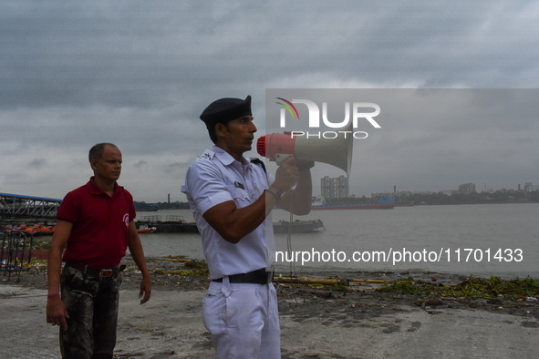 Police officials patrol a riverside in Kolkata, India, on October 24, 2024, as a precautionary measure ahead of the landfall of Cyclone Dana...