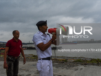 Police officials patrol a riverside in Kolkata, India, on October 24, 2024, as a precautionary measure ahead of the landfall of Cyclone Dana...