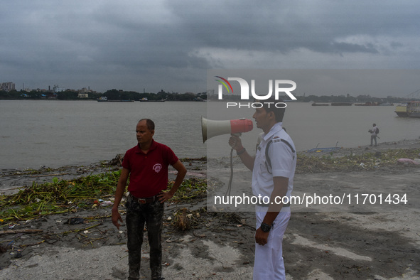 Police officials patrol a riverside in Kolkata, India, on October 24, 2024, as a precautionary measure ahead of the landfall of Cyclone Dana...