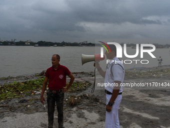 Police officials patrol a riverside in Kolkata, India, on October 24, 2024, as a precautionary measure ahead of the landfall of Cyclone Dana...