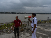 Police officials patrol a riverside in Kolkata, India, on October 24, 2024, as a precautionary measure ahead of the landfall of Cyclone Dana...